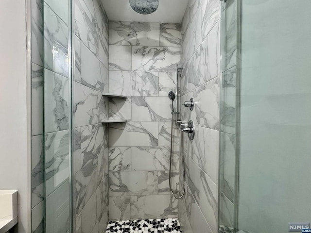 bathroom with a tile shower