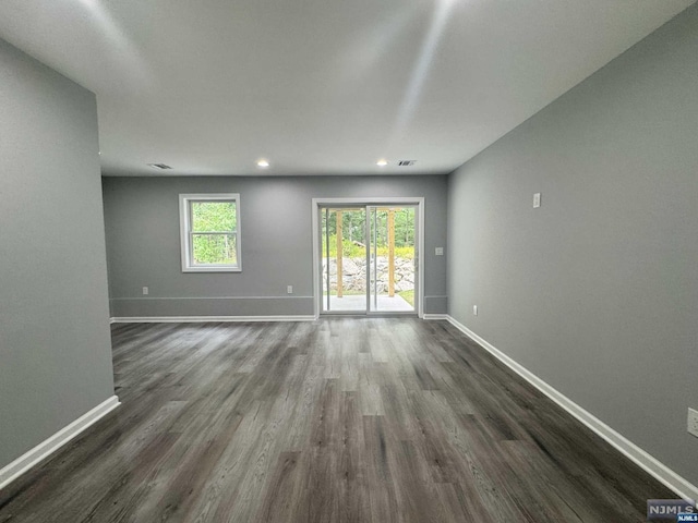 empty room with dark hardwood / wood-style floors