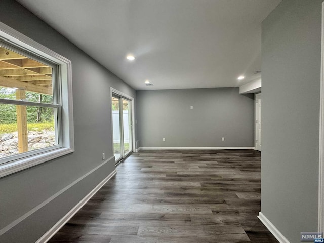 spare room with dark hardwood / wood-style flooring