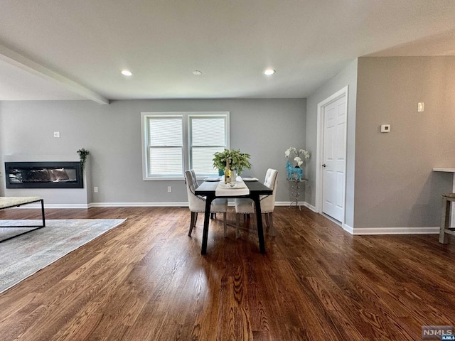 dining area with dark hardwood / wood-style flooring