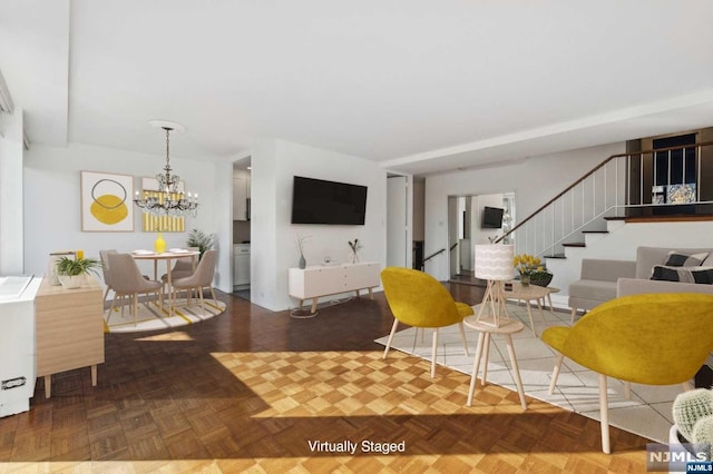 living room featuring an inviting chandelier and parquet floors