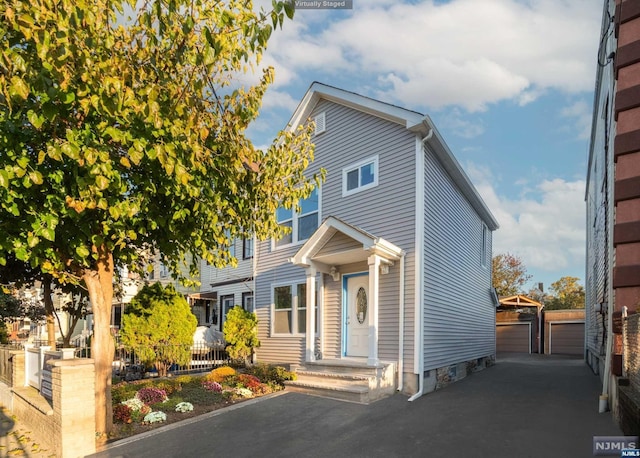 view of front facade featuring an outbuilding and a garage