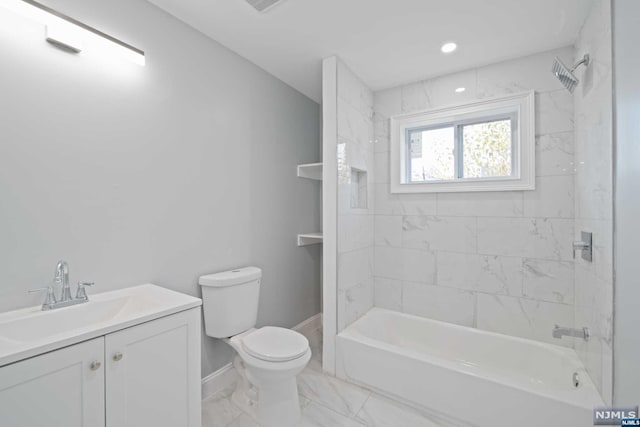 full bathroom featuring vanity, toilet, and tiled shower / bath