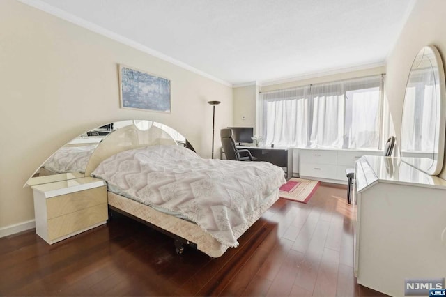 bedroom featuring crown molding, dark wood finished floors, and baseboards