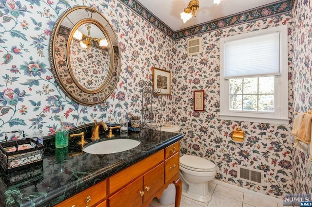 bathroom featuring vanity, visible vents, wallpapered walls, tile patterned flooring, and toilet