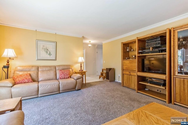 living area with crown molding and carpet