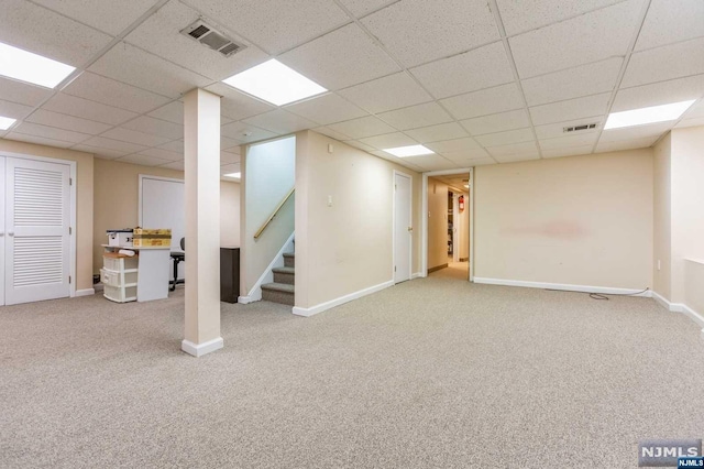 finished basement with stairs, carpet flooring, baseboards, and visible vents