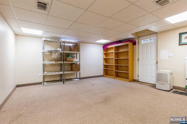 finished basement featuring visible vents, baseboards, and carpet