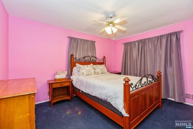 carpeted bedroom featuring baseboards and a ceiling fan