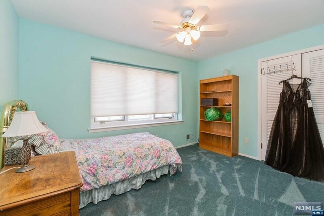 carpeted bedroom featuring a ceiling fan, baseboards, and a closet