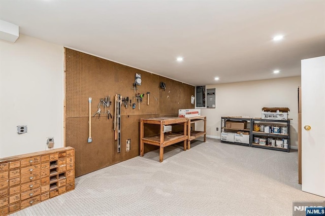 miscellaneous room featuring recessed lighting, a workshop area, and carpet