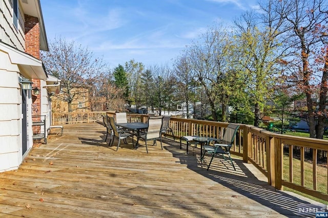 wooden deck featuring outdoor dining area