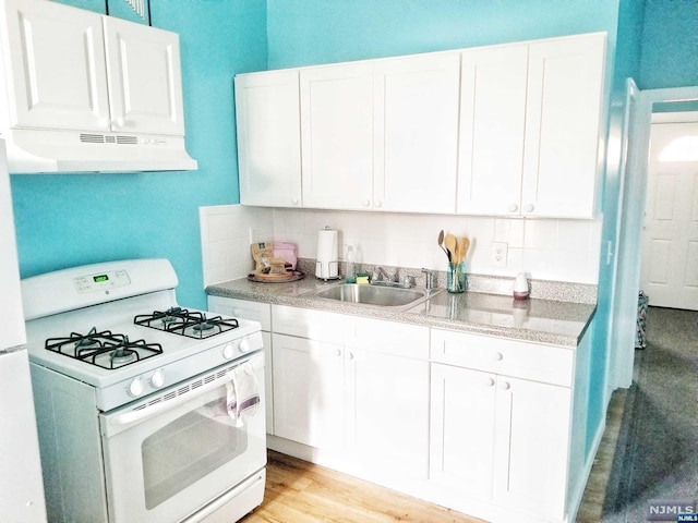 kitchen featuring light hardwood / wood-style floors, white cabinetry, white range with gas cooktop, and sink