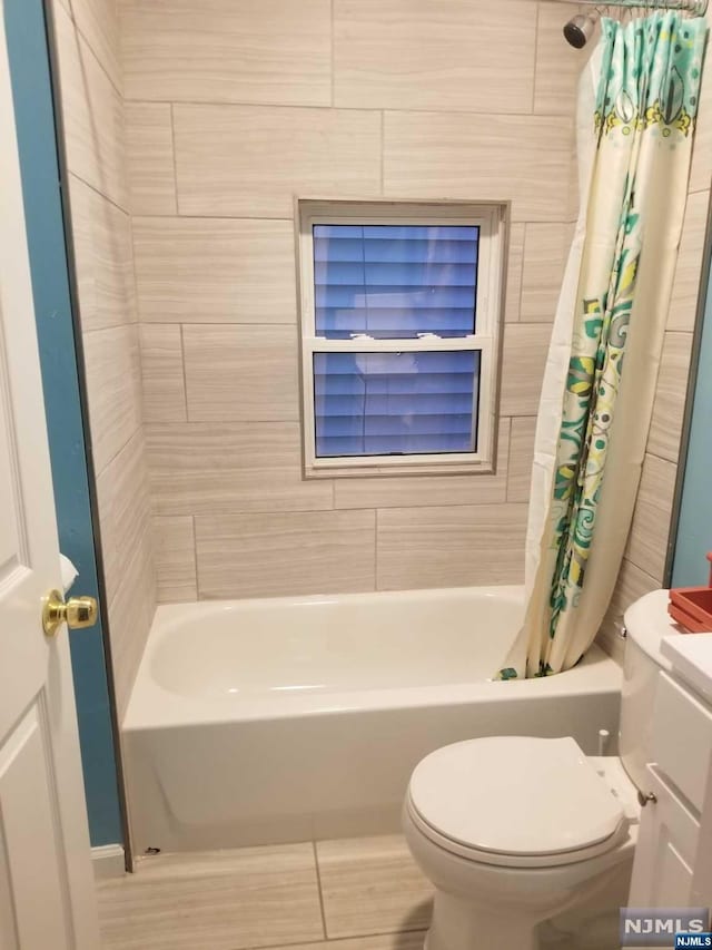 bathroom with shower / tub combo and toilet