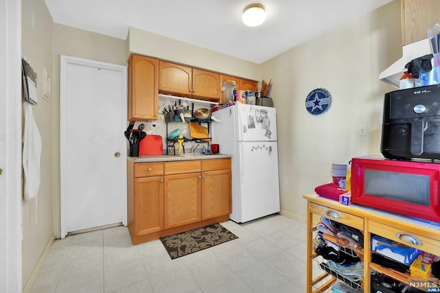 kitchen featuring white refrigerator and light tile patterned floors