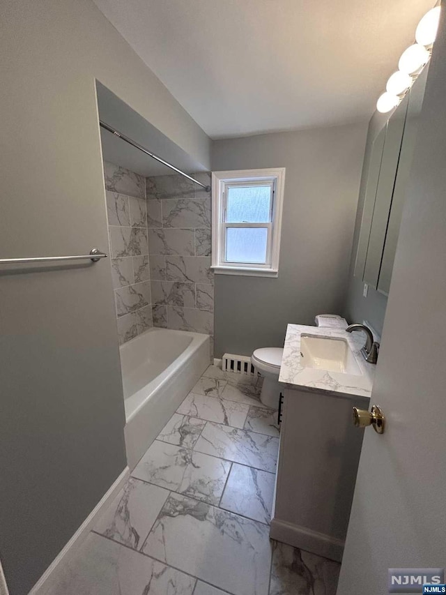 full bathroom featuring vanity, a baseboard radiator, toilet, and tiled shower / bath combo