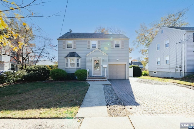 view of front facade with a garage and a front lawn