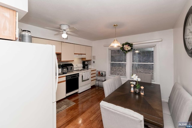 kitchen featuring decorative light fixtures, ceiling fan, dark hardwood / wood-style floors, and white appliances