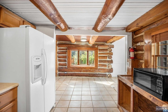 kitchen with light tile patterned flooring, white refrigerator with ice dispenser, wooden ceiling, log walls, and beam ceiling