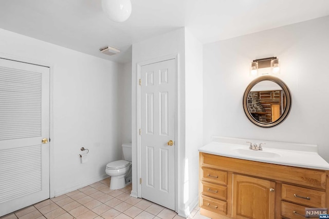 bathroom featuring tile patterned floors, vanity, and toilet