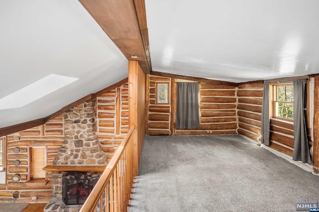 bonus room with log walls, carpet floors, and lofted ceiling with skylight