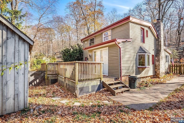 view of side of property with a wooden deck