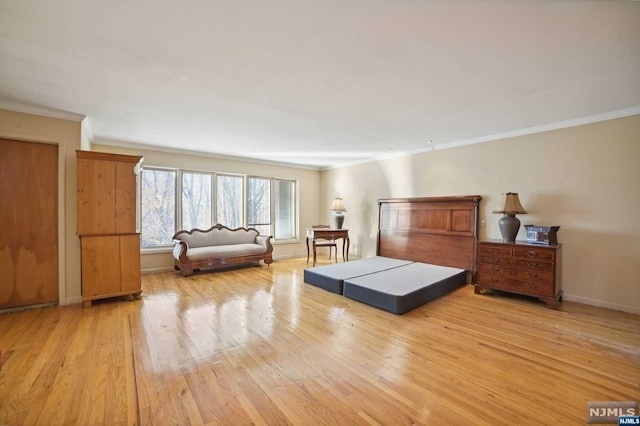 bedroom featuring light hardwood / wood-style floors and crown molding