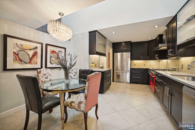 dining room with light tile patterned floors, a notable chandelier, and sink