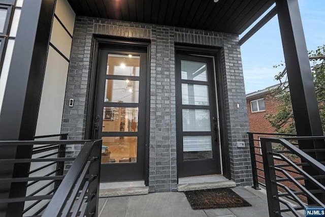 view of exterior entry with a porch