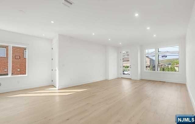 unfurnished living room featuring light hardwood / wood-style flooring