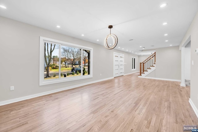 unfurnished living room with light wood-type flooring