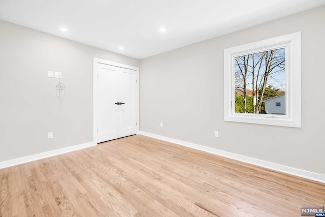 empty room with light hardwood / wood-style flooring