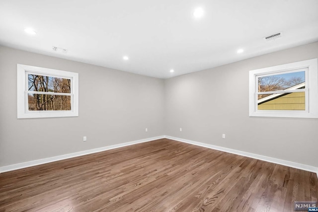 unfurnished room with hardwood / wood-style floors