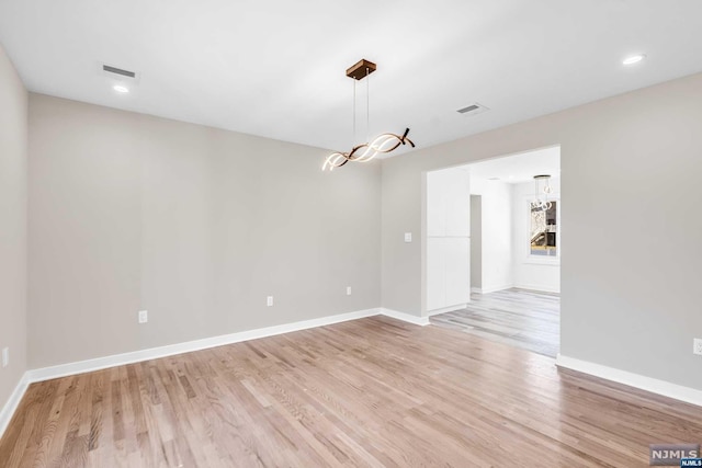 spare room with light hardwood / wood-style floors