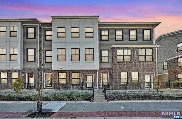 view of outdoor building at dusk