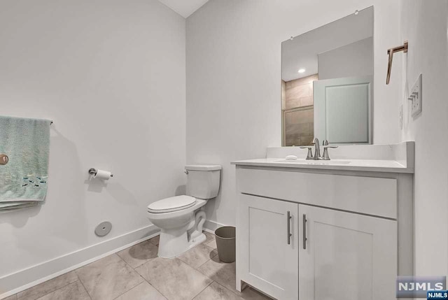 bathroom featuring tile patterned floors, vanity, and toilet