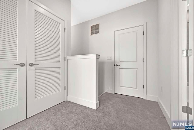 clothes washing area featuring carpet floors