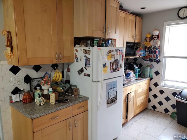 kitchen featuring light tile patterned floors and white refrigerator