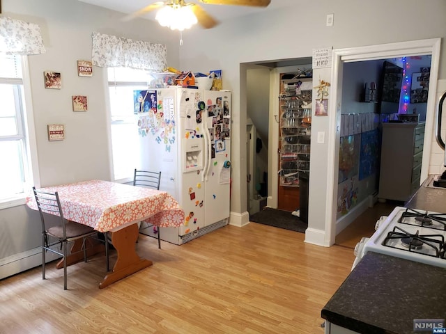 kitchen featuring ceiling fan, light hardwood / wood-style flooring, and white appliances