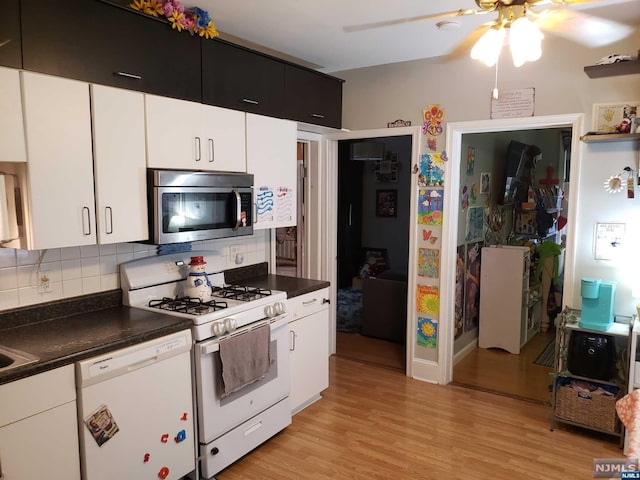 kitchen with white cabinets, light hardwood / wood-style floors, white appliances, and backsplash