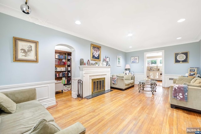 living room with light hardwood / wood-style flooring and ornamental molding