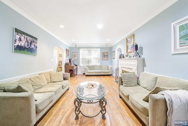 living room featuring light hardwood / wood-style flooring and ornamental molding