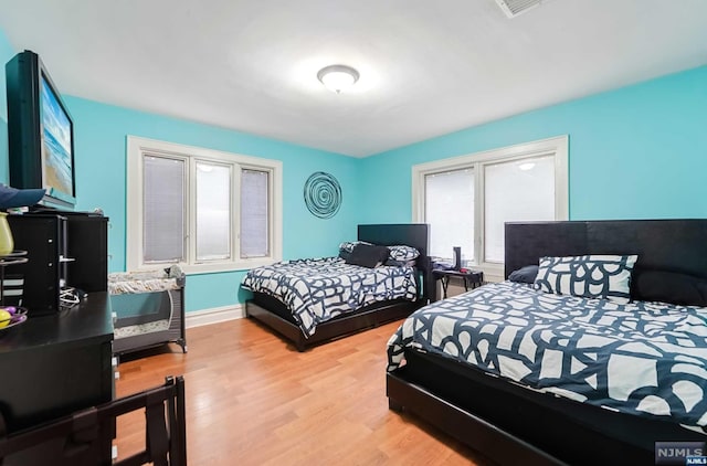 bedroom with light wood-type flooring