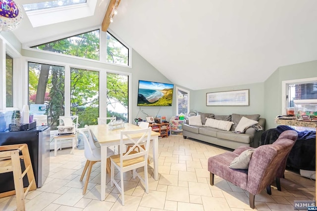 tiled living room featuring beamed ceiling, a skylight, and high vaulted ceiling