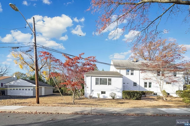 view of front of house featuring a garage and an outdoor structure