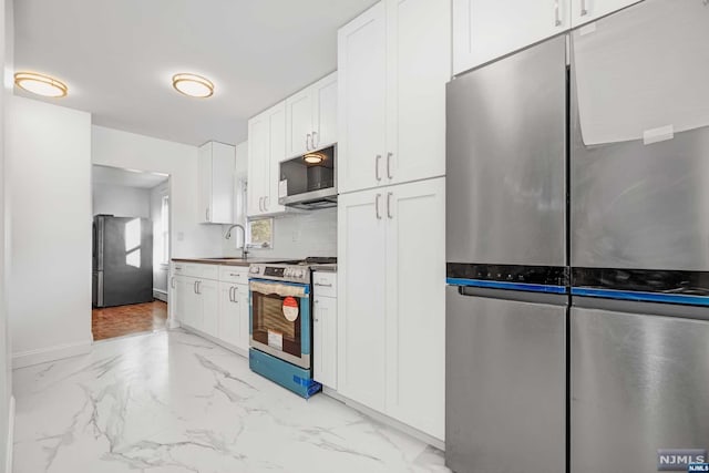 kitchen with white cabinetry, sink, and appliances with stainless steel finishes