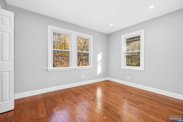 spare room with hardwood / wood-style floors