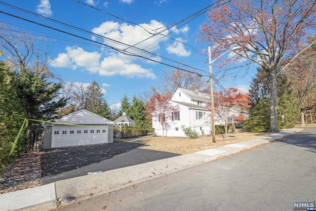 view of property with a garage and an outdoor structure