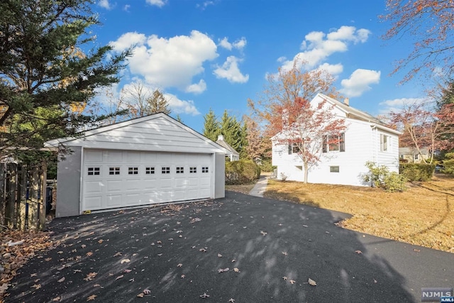 exterior space with an outbuilding and a garage