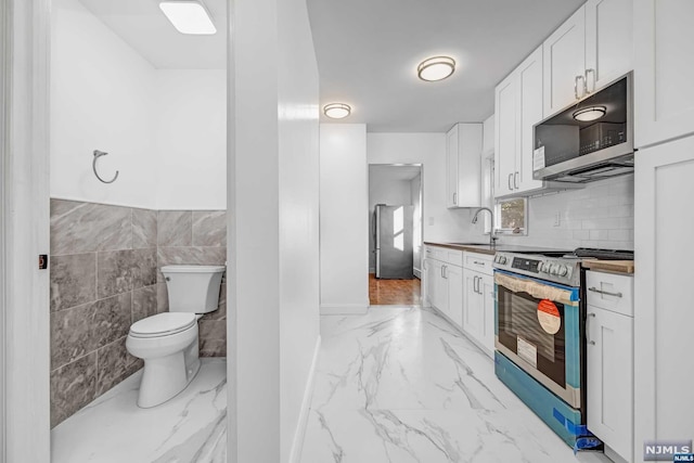 kitchen with white cabinets, sink, and appliances with stainless steel finishes